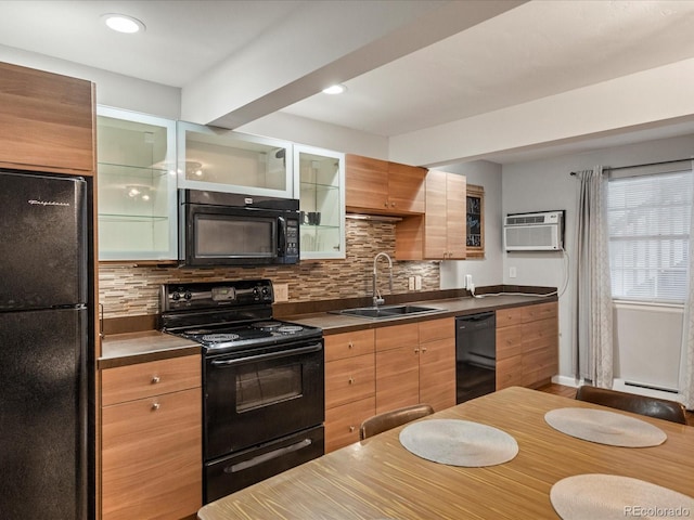 kitchen with sink, decorative backsplash, black appliances, and a wall mounted AC