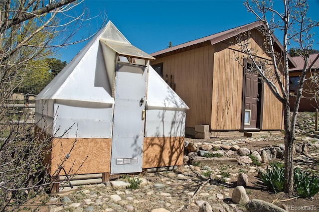 view of side of property featuring an outbuilding