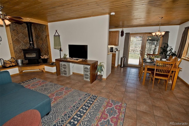 tiled living room with a wood stove, french doors, wood ceiling, and ceiling fan with notable chandelier