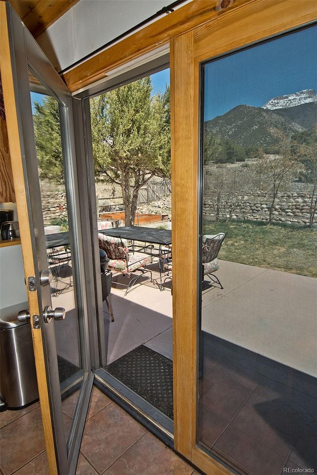 doorway featuring tile patterned flooring and a mountain view