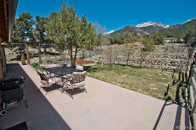 view of patio / terrace featuring a mountain view and a grill