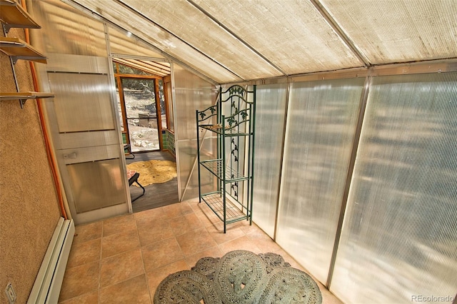 interior space with lofted ceiling and a baseboard heating unit