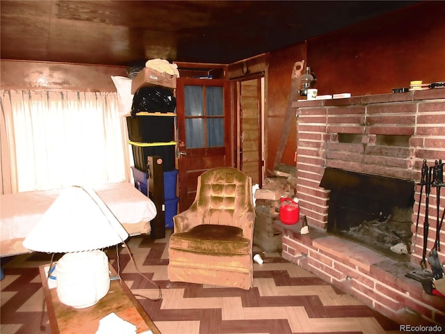 interior space featuring a brick fireplace and parquet flooring