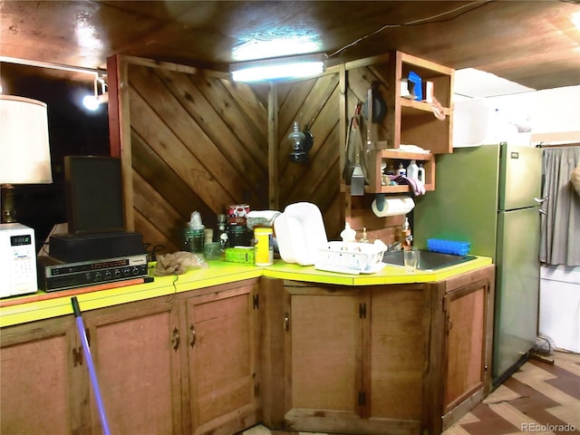 162 County Road-114, Bailey, CO 80421 - kitchen with white microwave, light countertops, brown cabinets, and freestanding refrigerator