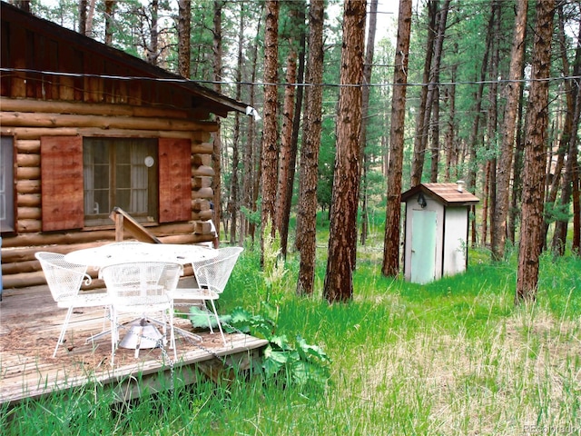 162 County Road-114, Bailey, CO 80421 - view of yard featuring a storage unit, outdoor dining space, and a view of trees