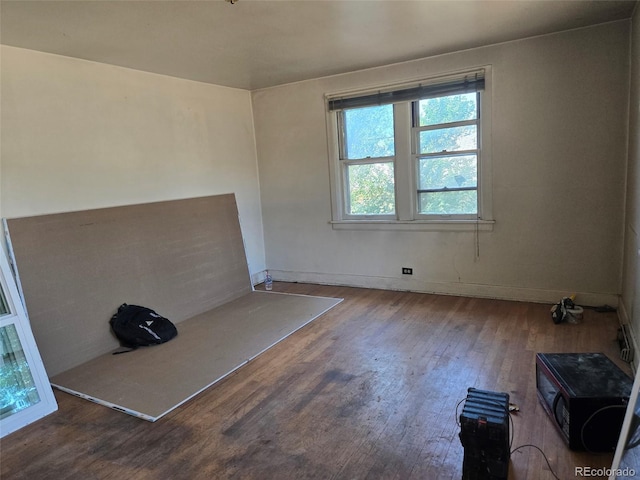 3350 S Eliot St, Englewood, CO 80110 - unfurnished living room with wood finished floors and baseboards