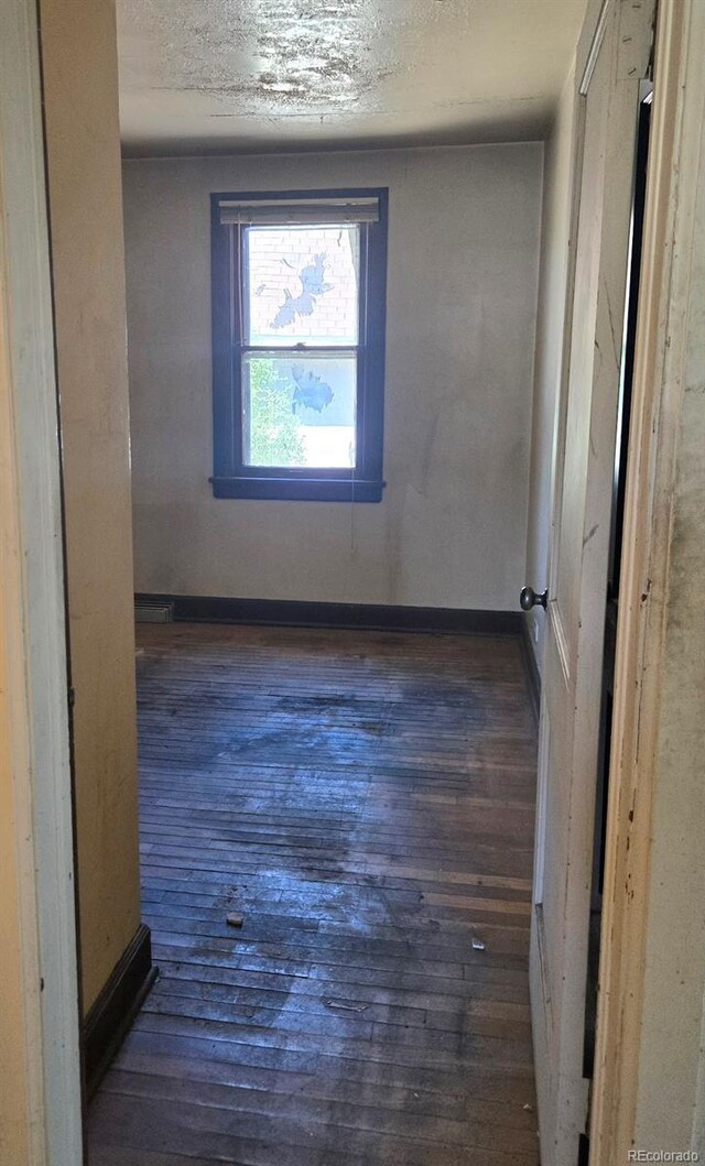 3350 S Eliot St, Englewood, CO 80110 - empty room with hardwood / wood-style flooring and a textured ceiling