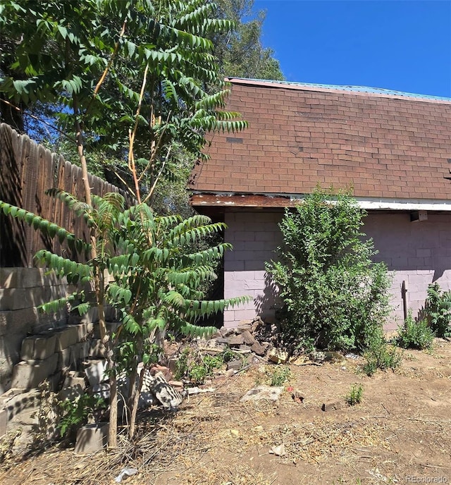3350 S Eliot St, Englewood, CO 80110 - view of property exterior with concrete block siding and a shingled roof