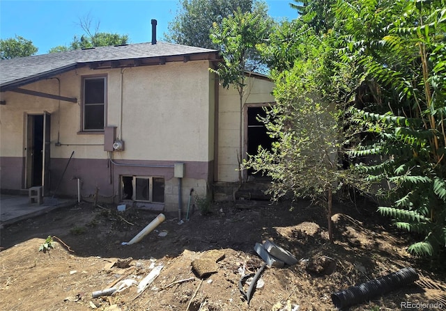 3350 S Eliot St, Englewood, CO 80110 - view of property exterior featuring a shingled roof