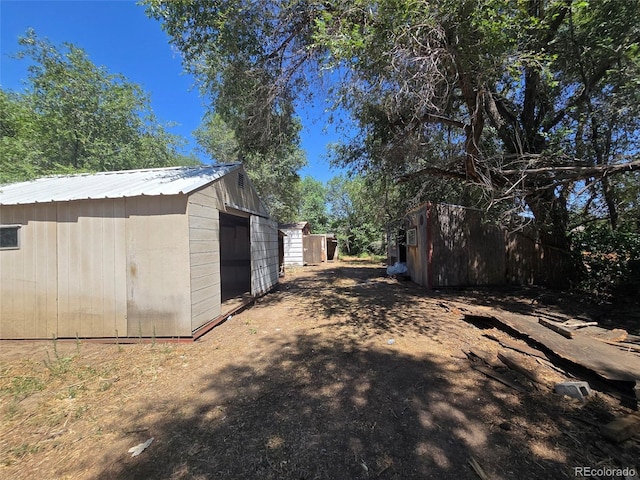 3350 S Eliot St, Englewood, CO 80110 - view of home's exterior with a metal roof and an outdoor structure