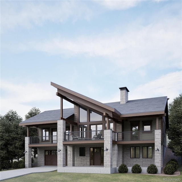 back of house featuring a yard, a balcony, and a garage