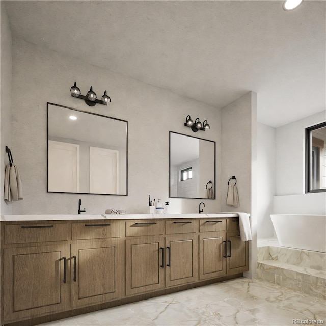 bathroom with vanity and a washtub