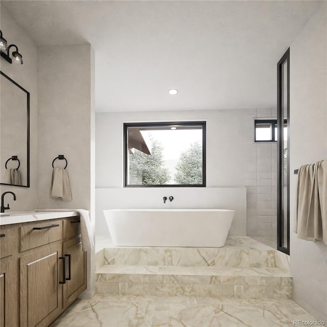 bathroom featuring vanity and a tub