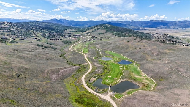 drone / aerial view with a water and mountain view