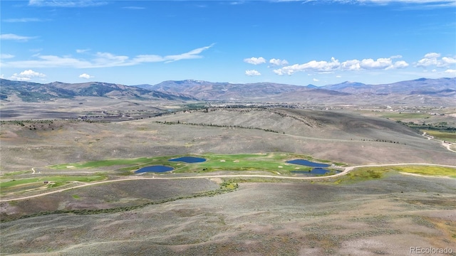 birds eye view of property featuring a mountain view