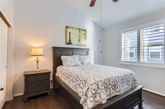 bedroom with lofted ceiling, a ceiling fan, baseboards, and dark wood-style flooring