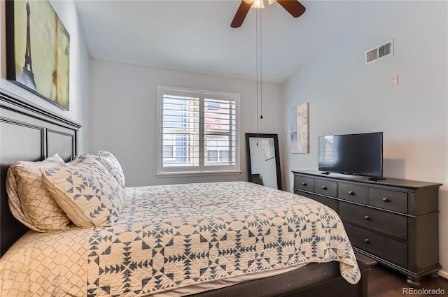 bedroom with vaulted ceiling, visible vents, and a ceiling fan