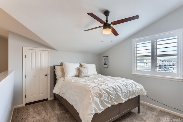 carpeted bedroom with lofted ceiling, a ceiling fan, and baseboards