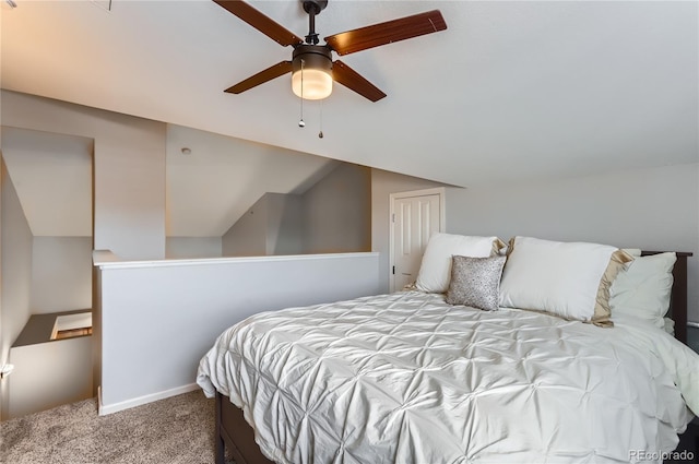 carpeted bedroom with a ceiling fan, vaulted ceiling, and baseboards