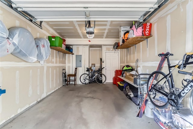 garage with electric panel and a garage door opener