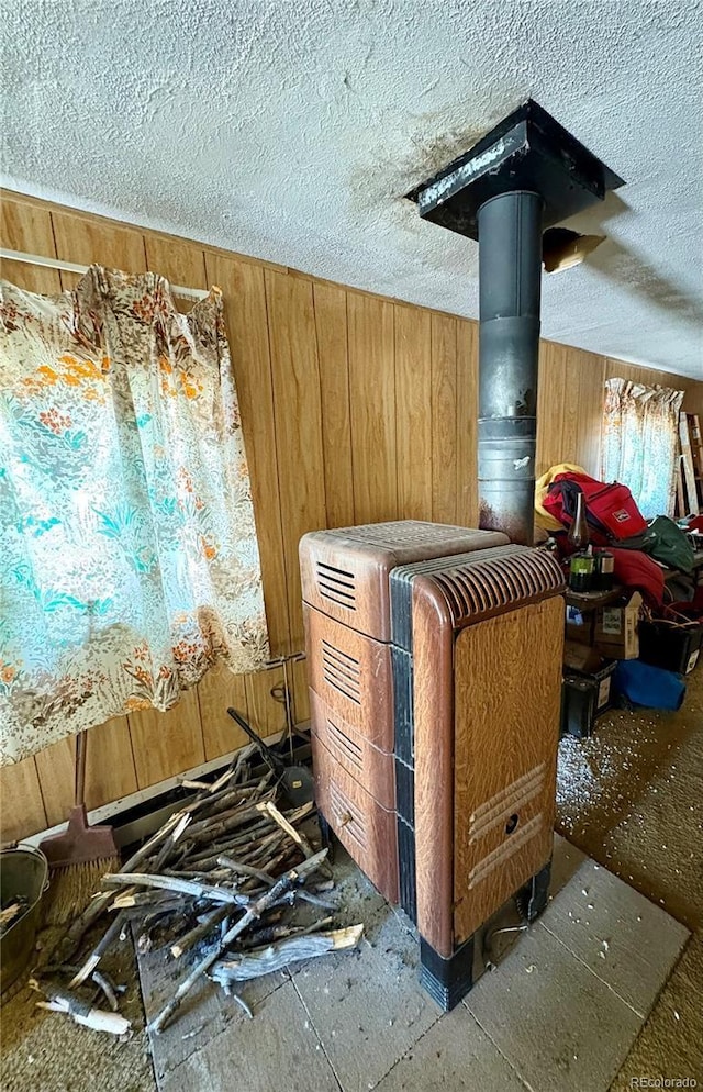 1245 Winchester Dr, Como, CO 80432 - detailed view of wooden walls, a textured ceiling, and a wood stove