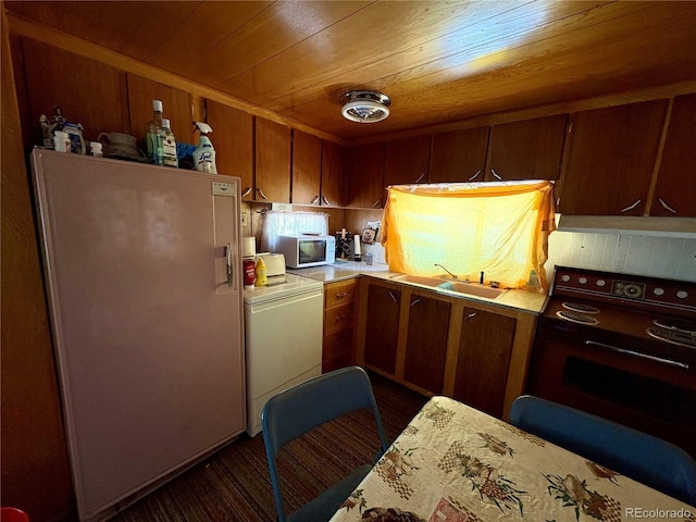 1245 Winchester Dr, Como, CO 80432 - kitchen with fridge, range with electric cooktop, white microwave, wooden ceiling, and washer / clothes dryer