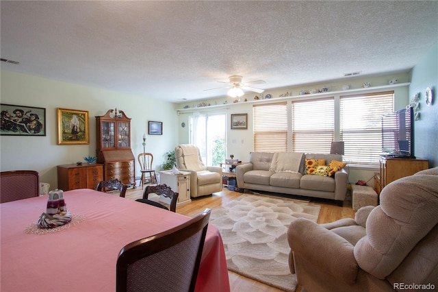 2296 E 109th Dr, Northglenn, CO 80233 - living area featuring ceiling fan, light wood finished floors, and a textured ceiling
