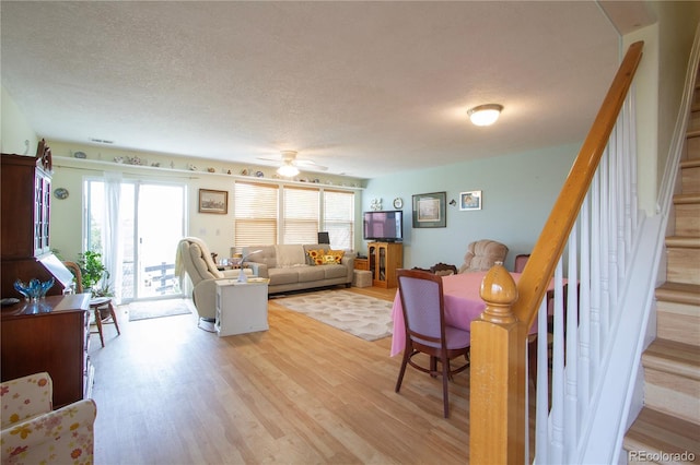 2296 E 109th Dr, Northglenn, CO 80233 - living room with light wood-style floors, plenty of natural light, a textured ceiling, and stairway