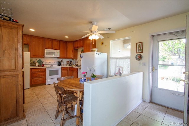 2296 E 109th Dr, Northglenn, CO 80233 - kitchen with white appliances, ceiling fan, brown cabinets, light countertops, and recessed lighting