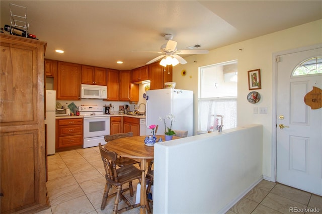 2296 E 109th Dr, Northglenn, CO 80233 - kitchen featuring white appliances, a sink, a ceiling fan, brown cabinets, and light countertops