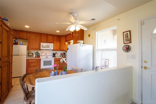 2296 E 109th Dr, Northglenn, CO 80233 - kitchen with white appliances, brown cabinetry, ceiling fan, recessed lighting, and light countertops