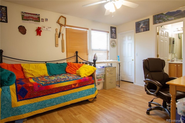 2296 E 109th Dr, Northglenn, CO 80233 - bedroom with light wood-style floors, ensuite bath, a sink, and a ceiling fan