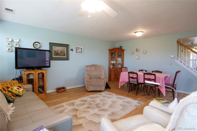 2296 E 109th Dr, Northglenn, CO 80233 - living room featuring ceiling fan, stairway, and wood finished floors