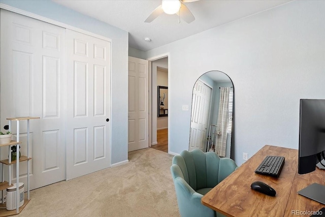 carpeted home office with ceiling fan