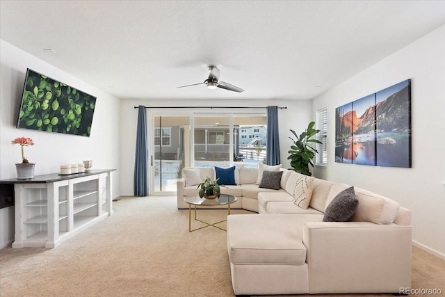 carpeted living room featuring ceiling fan