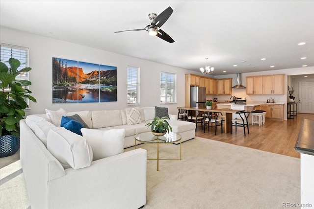 living room with sink, light hardwood / wood-style flooring, and ceiling fan