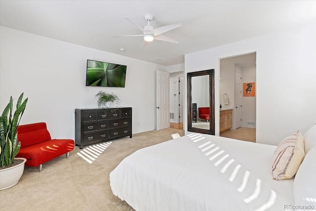 bedroom featuring carpet, ceiling fan, and ensuite bathroom