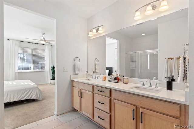 bathroom featuring ceiling fan, tile patterned floors, a shower with door, and vanity