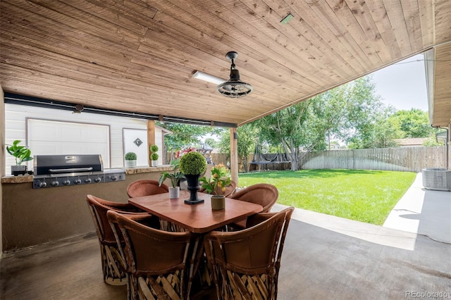 9170 Aspen Dr, Thornton, CO 80229 - fenced backyard featuring a patio area, exterior kitchen, outdoor dining area, and a trampoline