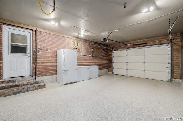 9170 Aspen Dr, Thornton, CO 80229 - garage featuring freestanding refrigerator and a garage door opener