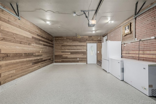 9170 Aspen Dr, Thornton, CO 80229 - garage with a garage door opener, freestanding refrigerator, wooden walls, and fridge