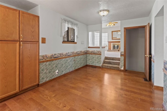 1400 S Knox Ct, Denver, CO 80219 - unfurnished dining area with light wood-style floors and wainscoting