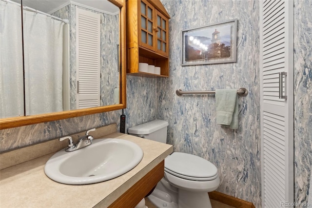 1400 S Knox Ct, Denver, CO 80219 - full bath featuring toilet, vanity, and a closet