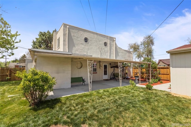 1400 S Knox Ct, Denver, CO 80219 - back of property featuring a patio area and stucco siding