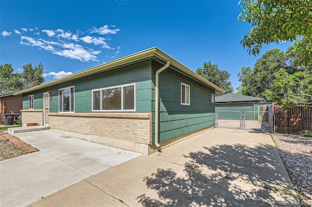 5556 Vaughn St, Denver, CO 80239 - view of side of property with a gate and brick siding