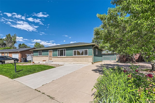 5556 Vaughn St, Denver, CO 80239 - ranch-style home featuring brick siding and a detached garage