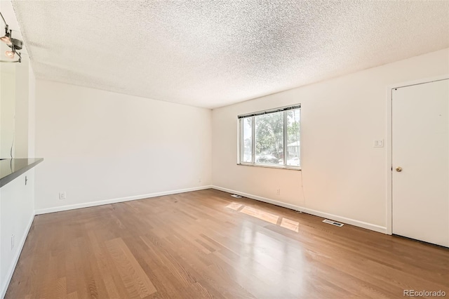 5556 Vaughn St, Denver, CO 80239 - unfurnished room featuring wood finished floors and a textured ceiling