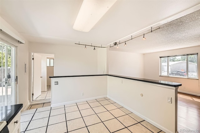 5556 Vaughn St, Denver, CO 80239 - spare room with track lighting and light tile patterned flooring
