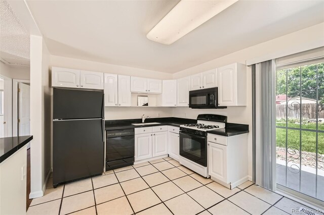 5556 Vaughn St, Denver, CO 80239 - kitchen featuring black appliances, dark countertops, white cabinets, and light tile patterned floors