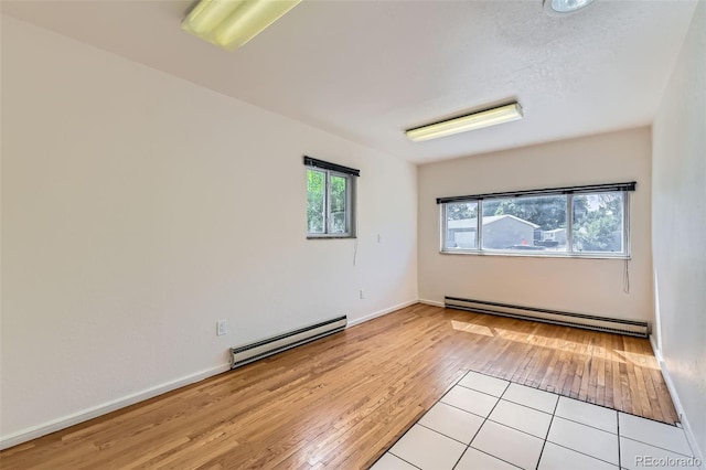 5556 Vaughn St, Denver, CO 80239 - unfurnished room featuring baseboard heating and light wood finished floors